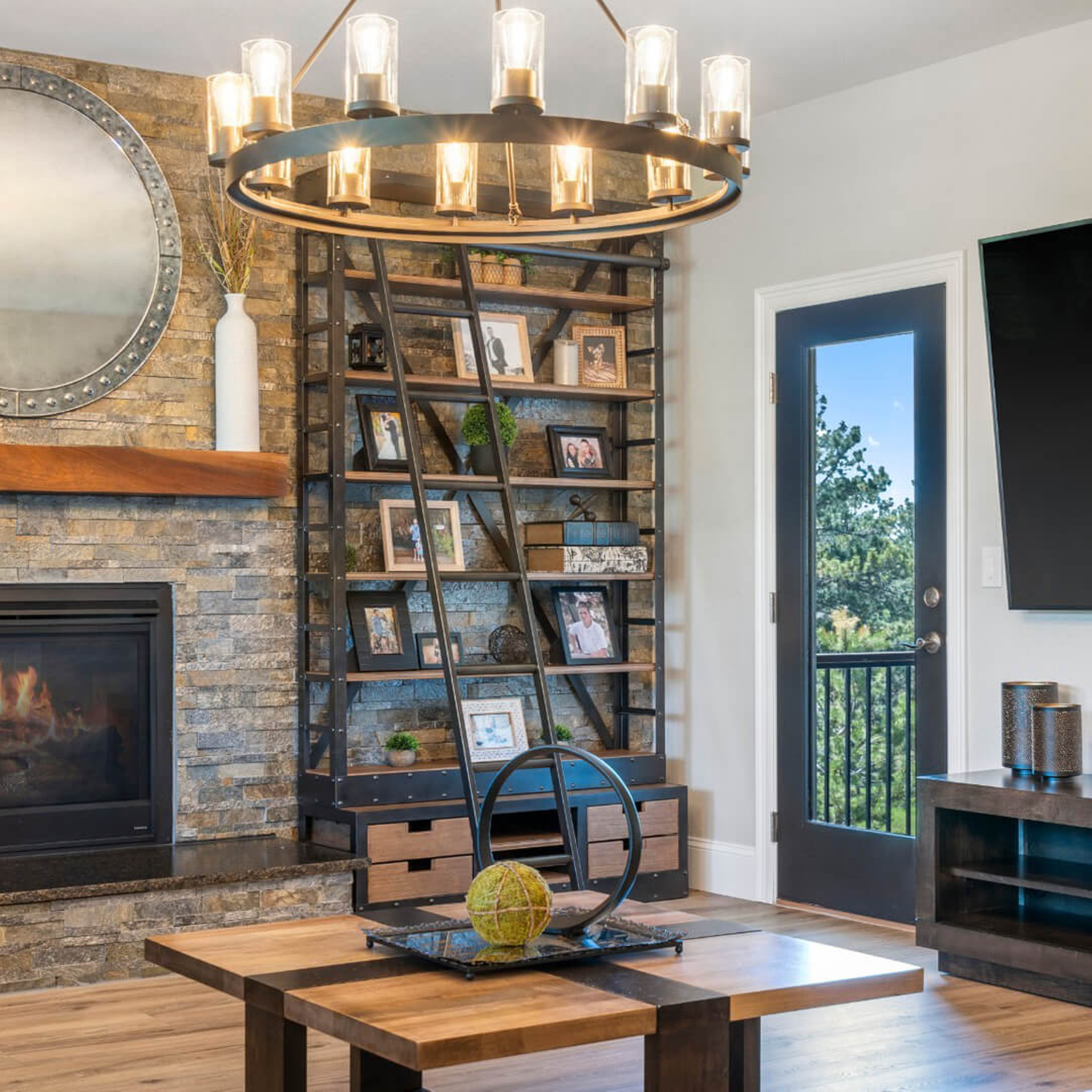 Modern steel framed bookcase next to a fireplace.